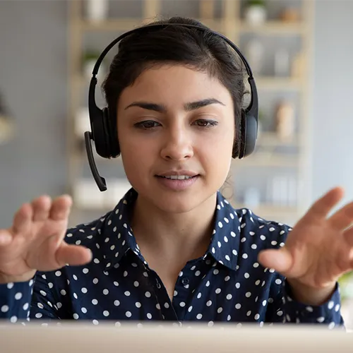 careers-hero young woman wearing headset in front of laptop